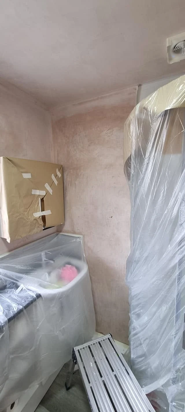 Plastering and surface preparation for damaged bathroom walls during a renovation in Norfolk