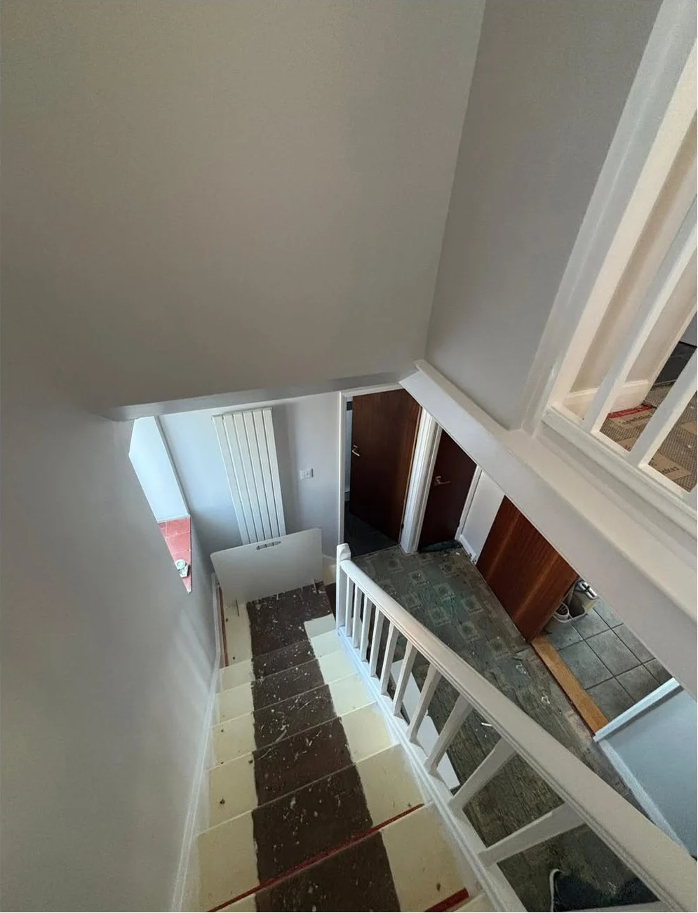Grey staircase after professional hallway and staircase decorating in Norfolk