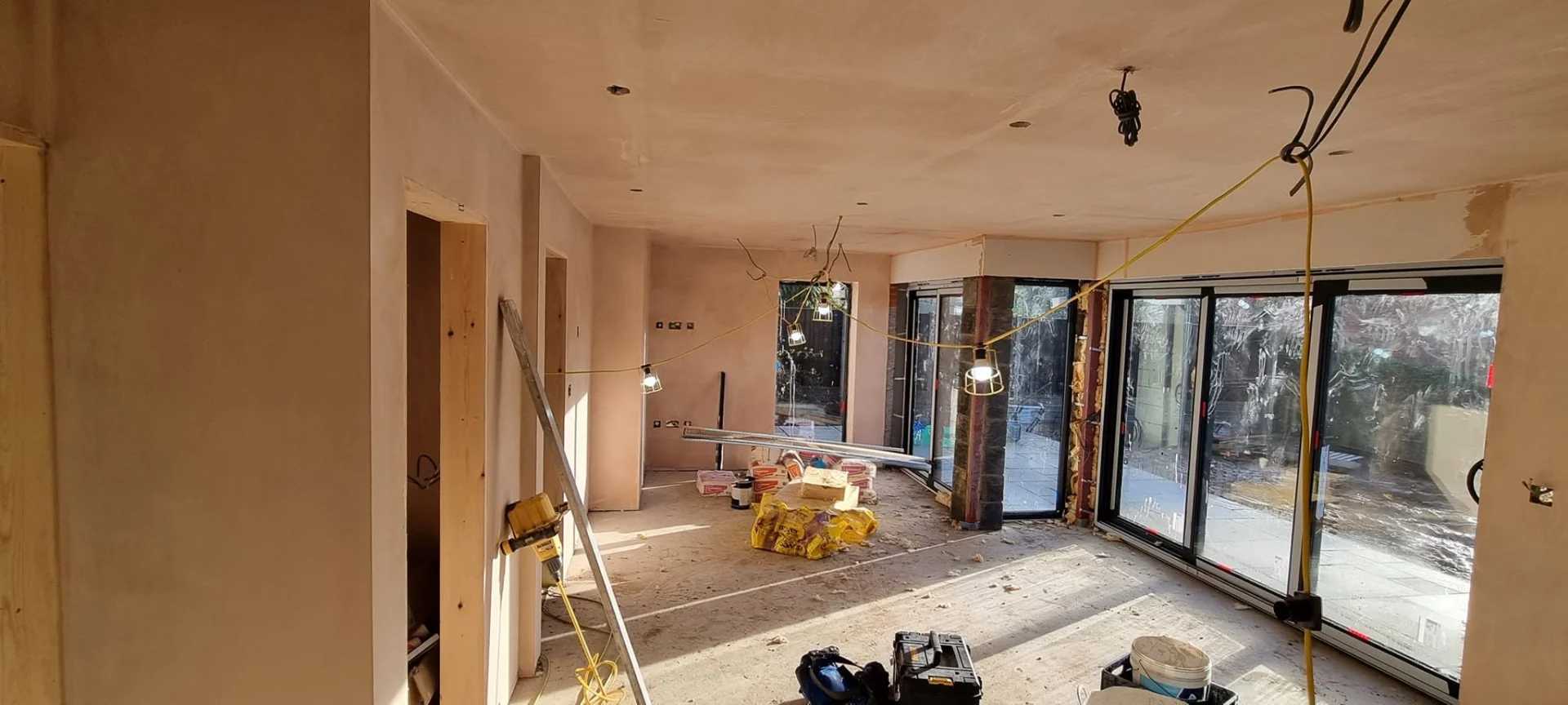 Plastering and surface preparation in progress during an open-plan renovation in Norfolk